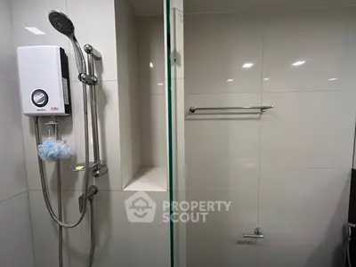 Modern bathroom with sleek shower and water heater, perfect for a comfortable living experience.