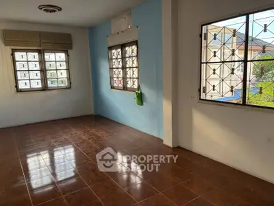 Spacious room with tiled floor and large windows offering natural light, ideal for customization.