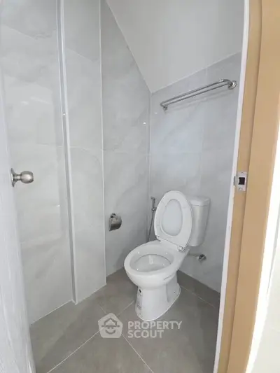 Modern bathroom with sleek tiles and contemporary toilet design