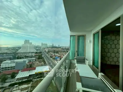 Stunning high-rise balcony with panoramic city and ocean views, perfect for relaxation and enjoying sunsets.