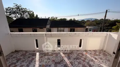 Charming balcony with scenic view of suburban homes and lush greenery, perfect for relaxation.