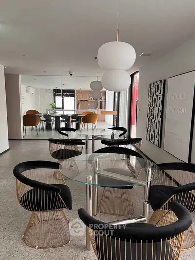 Stylish modern dining area with elegant chairs and glass table in a contemporary apartment.