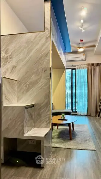 Modern living room with stylish marble staircase and cozy seating area