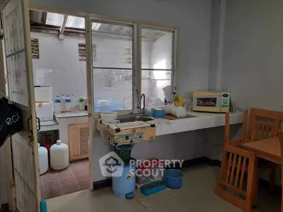 Compact kitchen with basic amenities and dining area