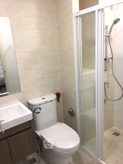 Modern bathroom with shower and sleek fixtures in a contemporary apartment.