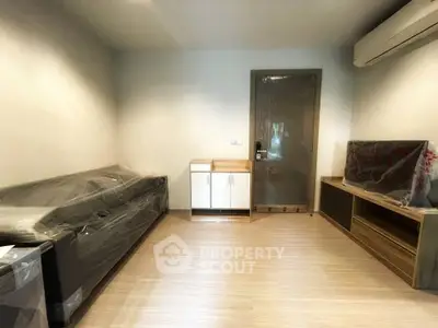 Modern living room with sleek furniture and air conditioning, perfect for comfortable living.