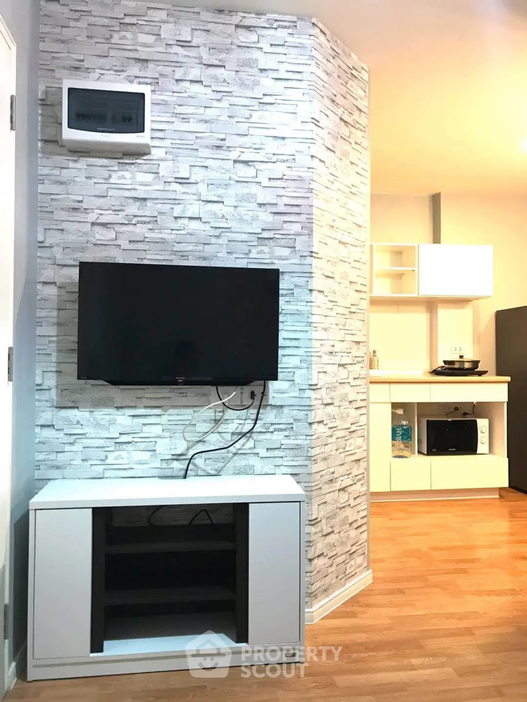 Modern living room with TV and stylish stone accent wall