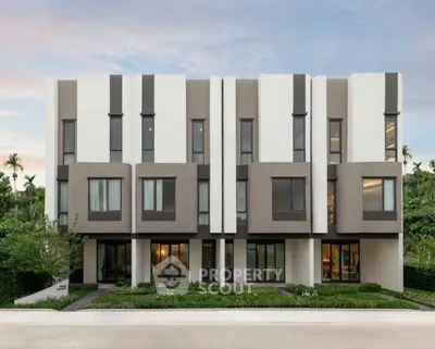 Modern architectural building exterior with sleek design and lush greenery, perfect for contemporary living.