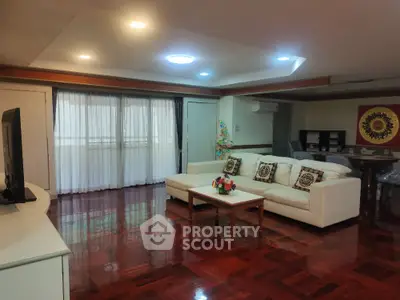 Spacious living room with elegant wooden flooring and modern decor