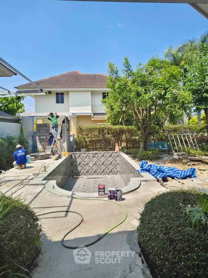 Charming backyard with pool under construction in suburban home setting.