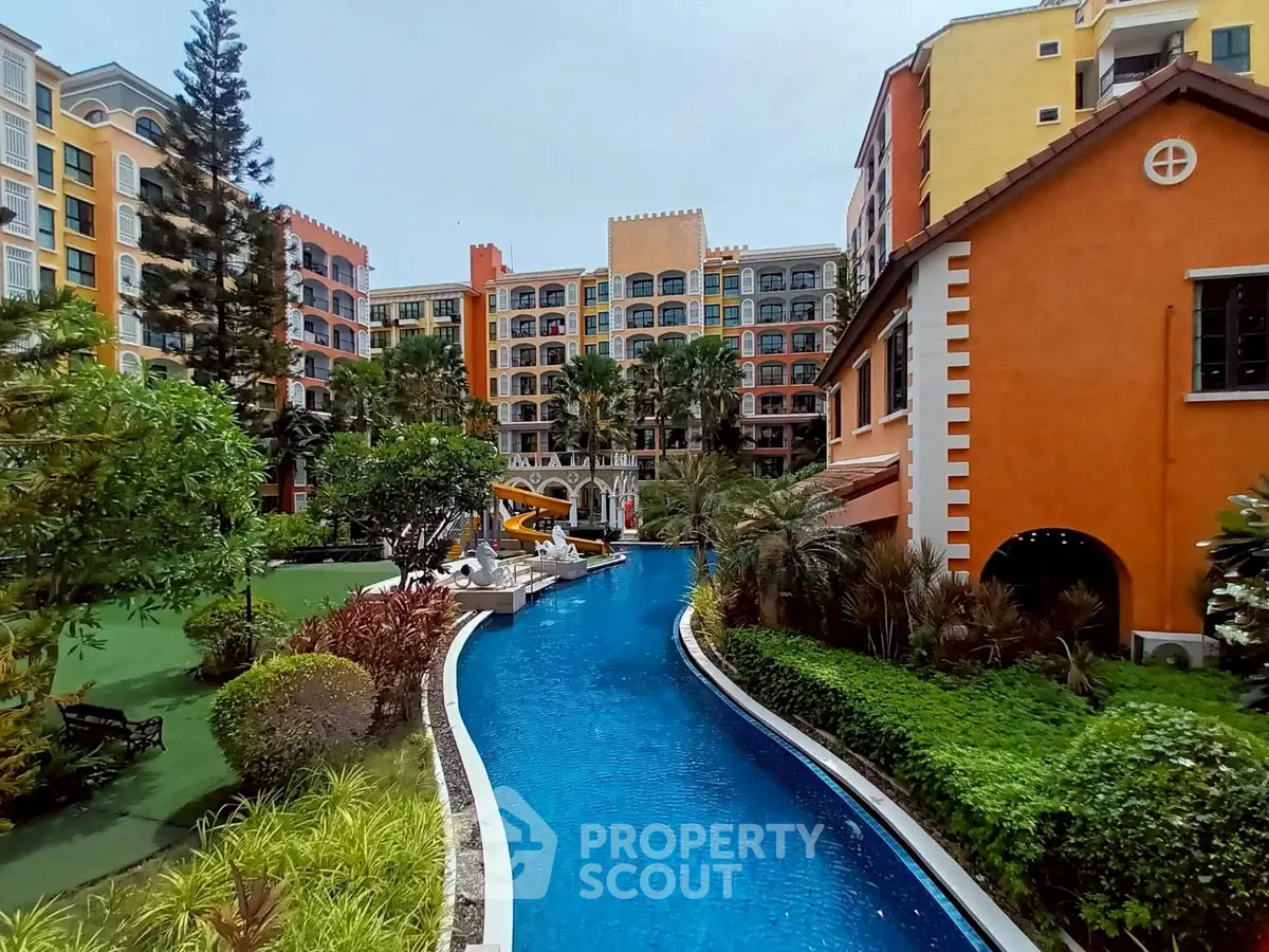 Luxurious residential complex with vibrant architecture and serene poolside view.