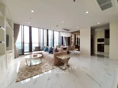 Luxurious open-plan living room with elegant decor and stunning city view