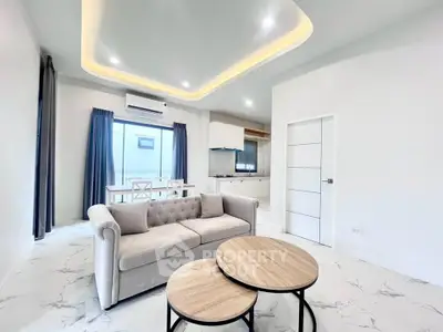 Modern living room with elegant sofa and stylish dining area in open layout apartment.