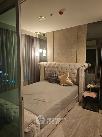 Luxurious bedroom with elegant decor and plush bed in modern apartment.