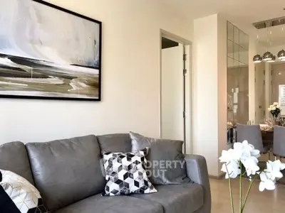 Modern living room with stylish decor and dining area in open layout apartment.