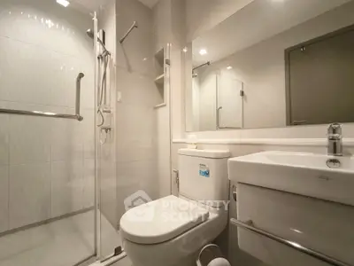 Modern bathroom with sleek shower and contemporary fixtures.