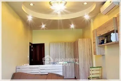 Modern living room with stylish ceiling lights and wooden furniture