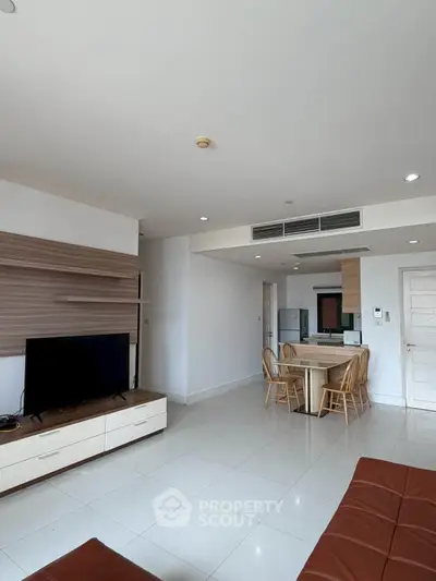 Spacious modern living room with open kitchen and stylish furniture in a bright apartment.