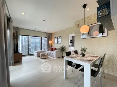 Modern open-plan living room with dining area and large windows in a stylish apartment.