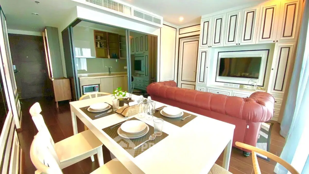 Luxurious open-layout living room with elegant kitchen and stylish decor.