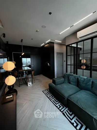 Modern living room with sleek black accents and large windows offering a stunning view.
