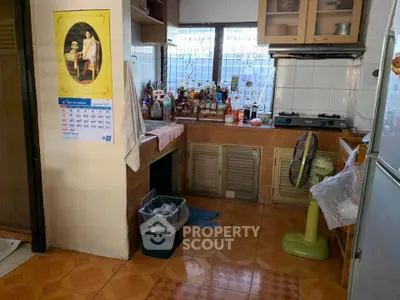 Cozy kitchen with gas stove and ample storage space, featuring a unique tile floor design.