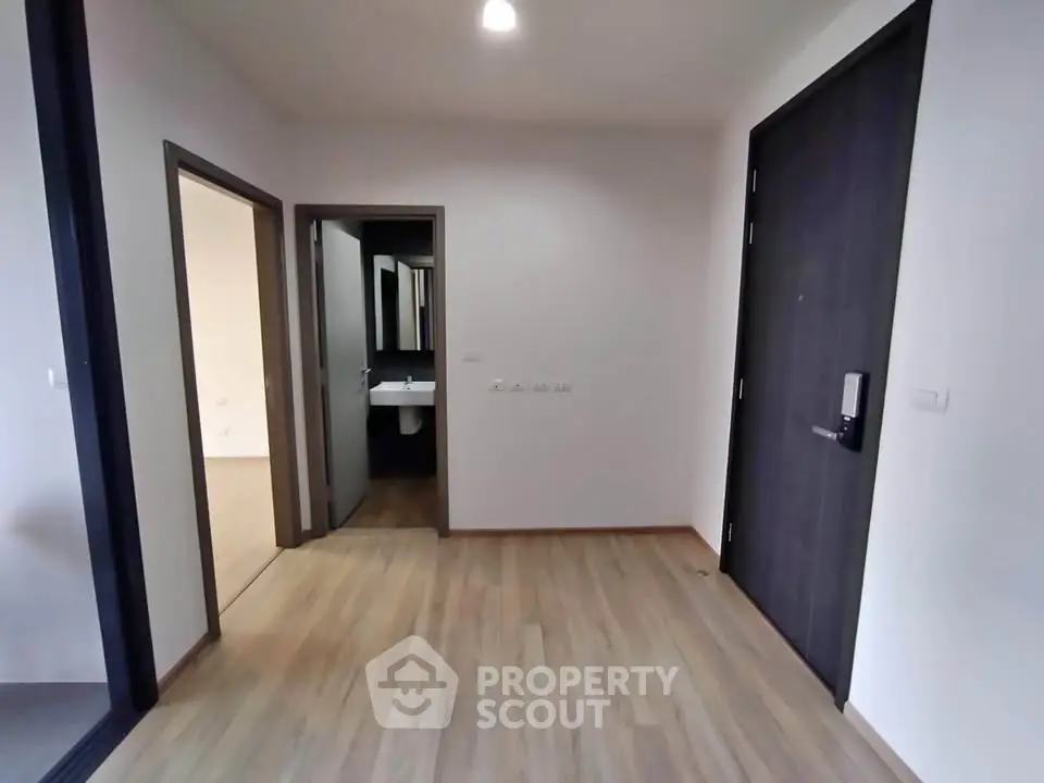 Modern apartment entrance with wooden flooring and sleek design