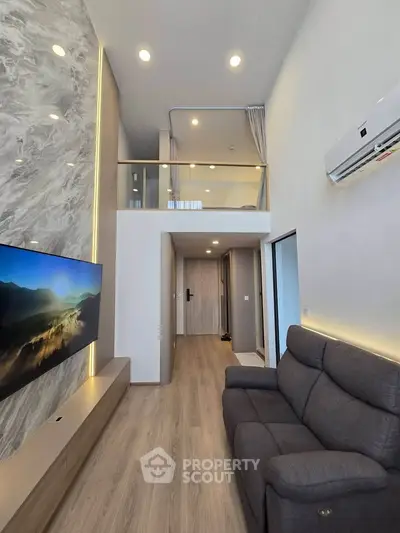 Modern loft-style living room with high ceiling and stylish decor