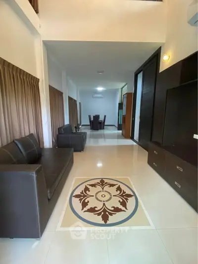 Spacious living room with elegant tile design and modern furniture
