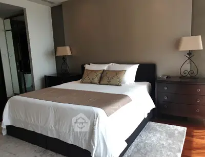 Luxurious bedroom with elegant decor and natural light, featuring a comfortable bed and stylish furnishings.
