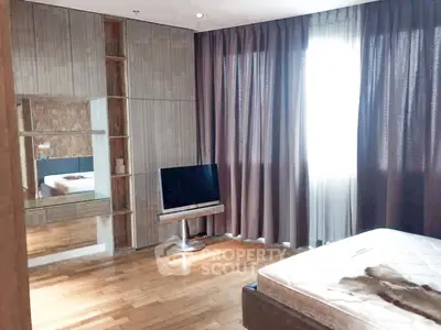Spacious bedroom with modern decor and natural light
