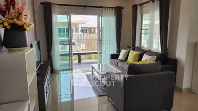 Charming living room with modern decor and garden view, perfect for relaxation and entertaining guests.
