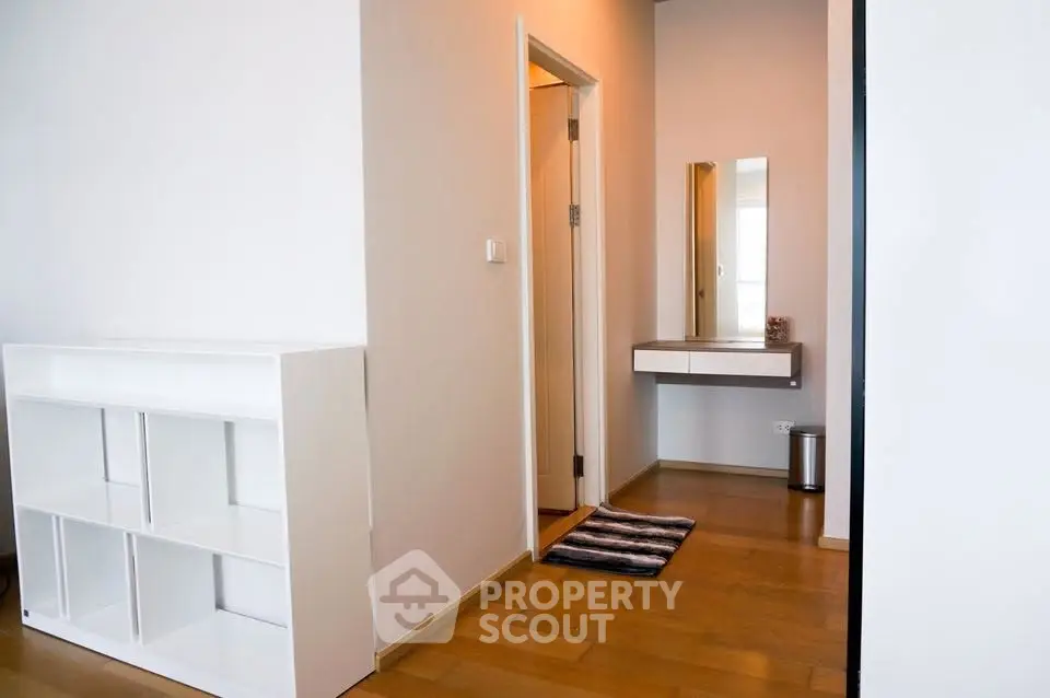 Modern interior with sleek shelving and minimalist decor in a bright hallway.