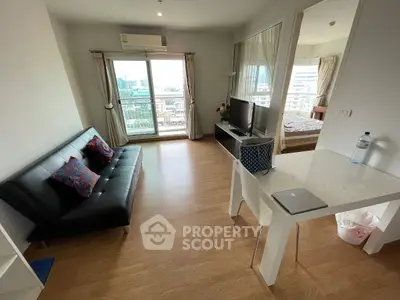 Modern open-plan living room with city view, featuring sleek furniture and natural light.