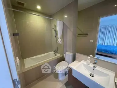 Modern bathroom with bathtub and sleek fixtures in a stylish apartment.