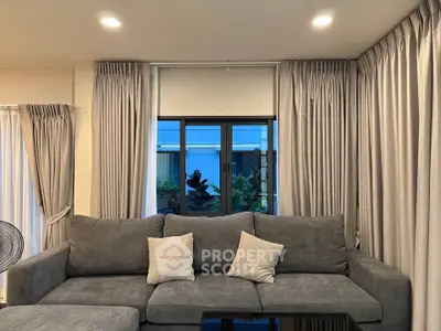 Modern living room with elegant gray sofa and stylish curtains