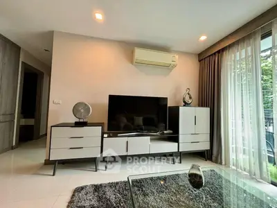 Modern living room with sleek furniture and large window for natural light