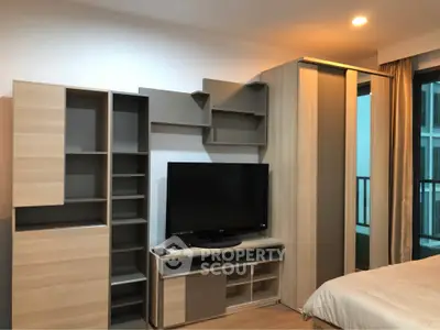 Modern bedroom with sleek storage and entertainment unit