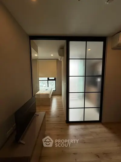 Modern apartment interior with sliding glass door and cozy bedroom view