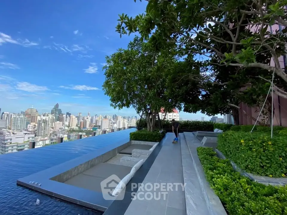 Luxurious rooftop infinity pool with stunning city skyline view and lush greenery.