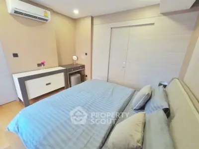 Modern bedroom with stylish decor and air conditioning in a cozy apartment.