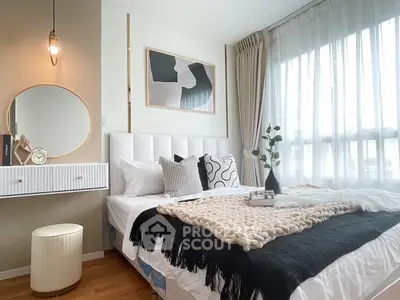 Chic bedroom with modern decor and large window for natural light.