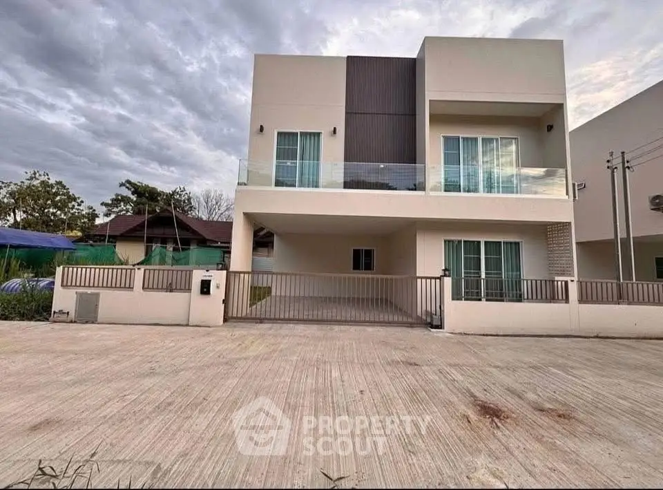 Modern two-story house with spacious driveway and contemporary design.
