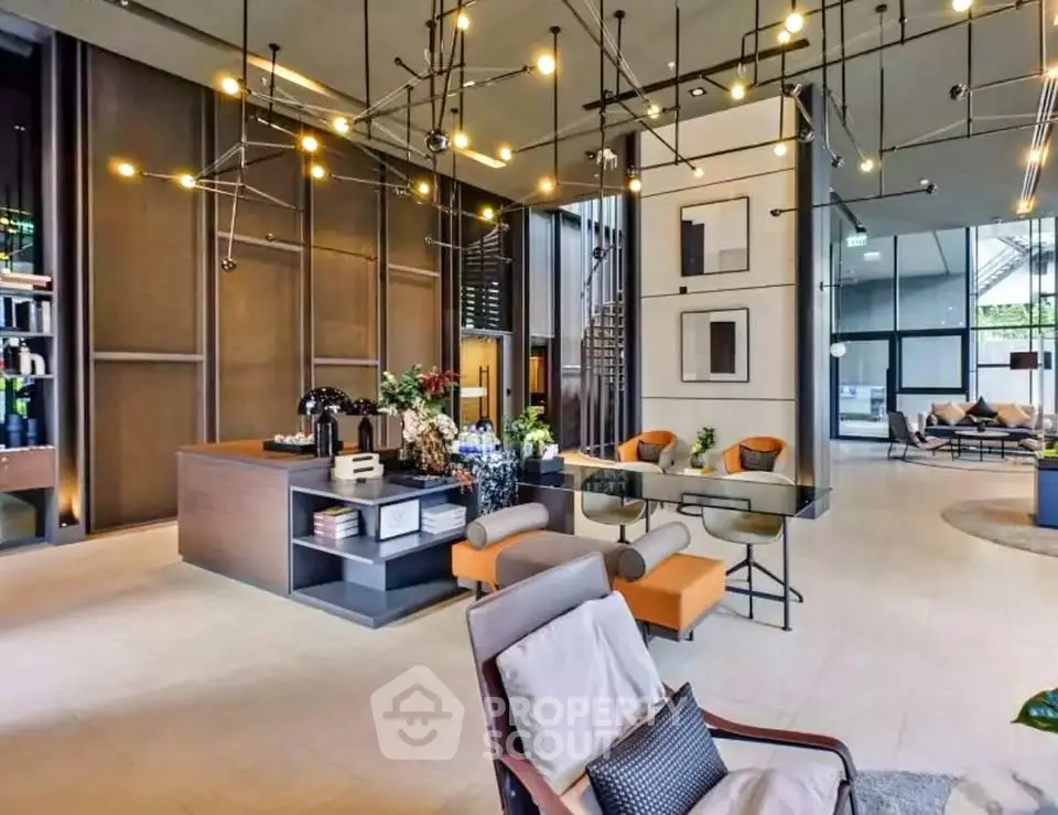 Luxurious modern lobby with stylish lighting and comfortable seating in upscale building.