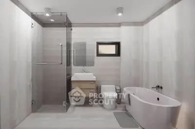 Modern bathroom with sleek design, featuring a glass shower and freestanding bathtub.