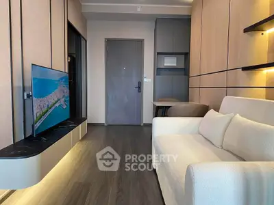 Modern living room with sleek design, featuring a wall-mounted TV and cozy white sofa.