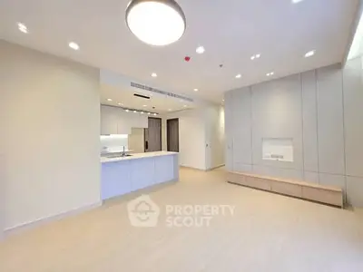 Spacious modern living room with open kitchen layout and sleek design