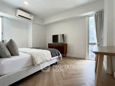 Spacious modern bedroom with elegant decor and natural light