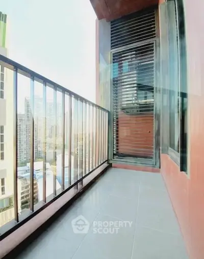Spacious balcony with city view in modern high-rise apartment