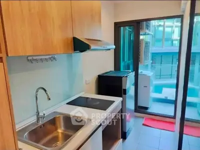Modern kitchen with sleek appliances and pool view, perfect for urban living.